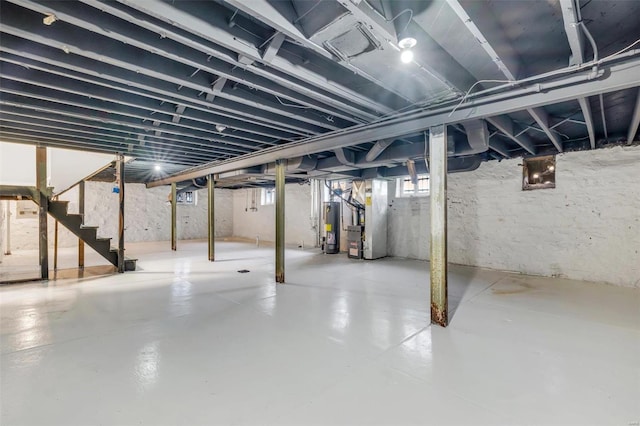 basement featuring heating unit and water heater