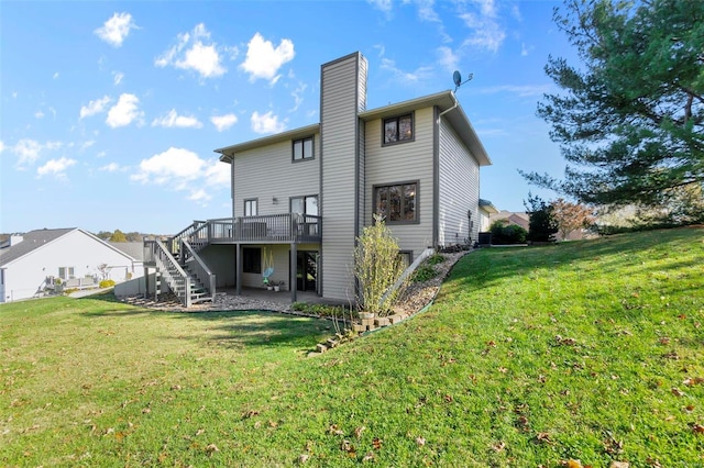 back of property with a yard and a wooden deck