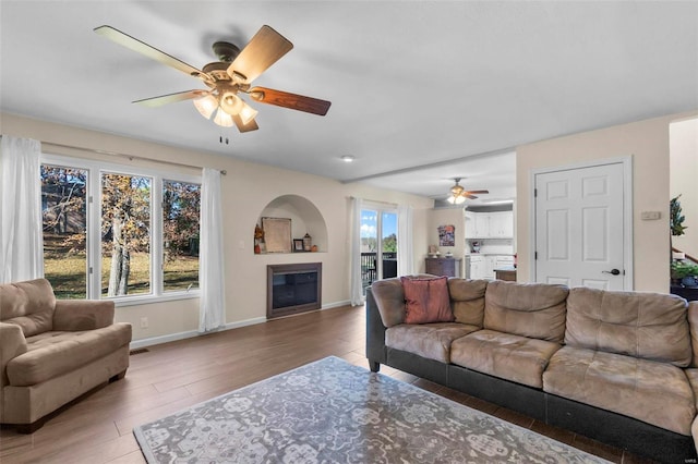 living room with ceiling fan and hardwood / wood-style flooring