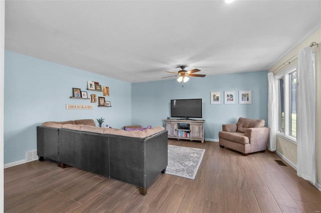 living room featuring ceiling fan and hardwood / wood-style floors