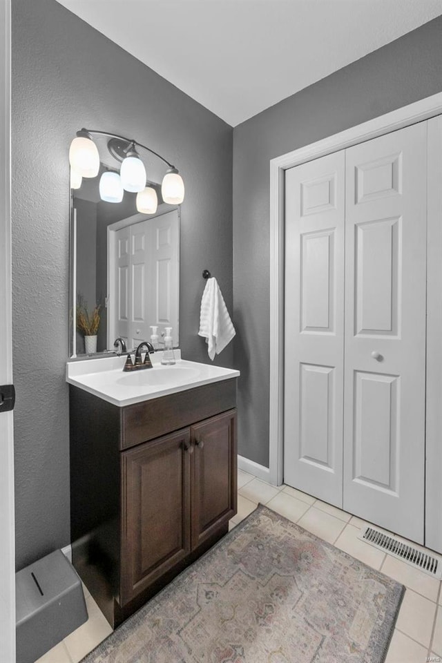 bathroom with tile patterned floors and vanity