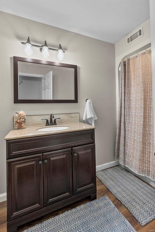 bathroom featuring wood-type flooring and vanity