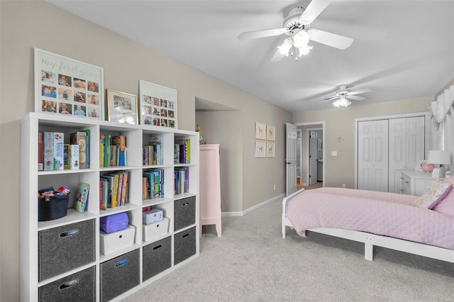 carpeted bedroom featuring ceiling fan and a closet