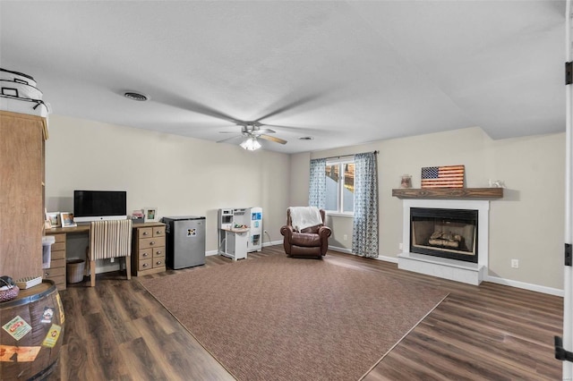 interior space featuring ceiling fan, a textured ceiling, and dark hardwood / wood-style flooring