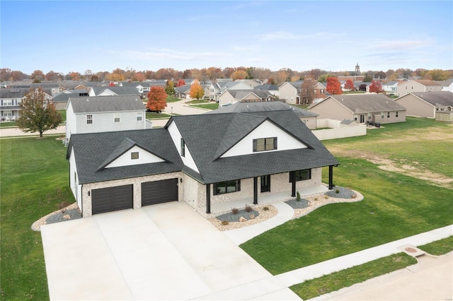 view of front of property featuring covered porch and a front yard