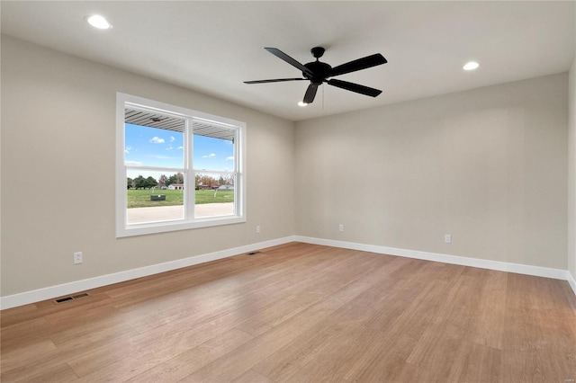 spare room featuring ceiling fan and light hardwood / wood-style flooring