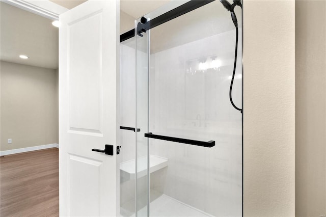 bathroom featuring wood-type flooring and walk in shower