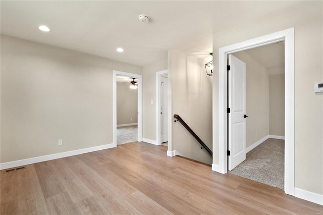 spare room featuring light hardwood / wood-style floors and ceiling fan