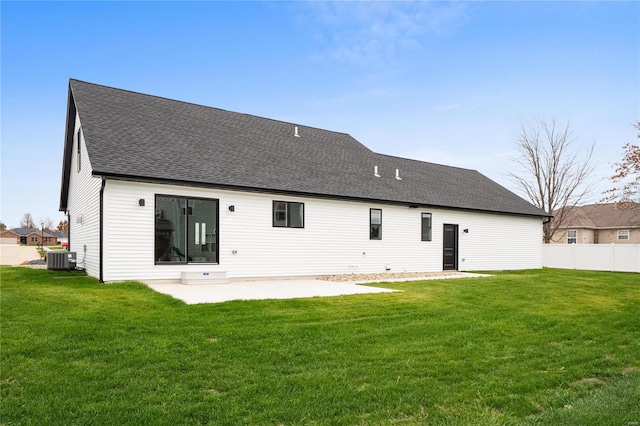 rear view of property featuring central air condition unit, a patio area, and a lawn