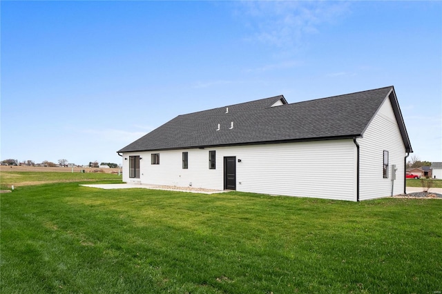 rear view of house with a patio and a lawn