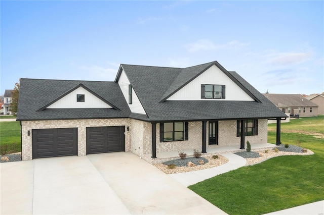 view of front facade featuring covered porch, a garage, and a front yard