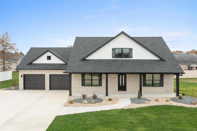 modern inspired farmhouse with a porch and a front yard