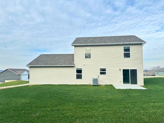 rear view of property with a lawn and central air condition unit