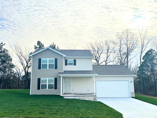 front facade featuring a garage and a front yard