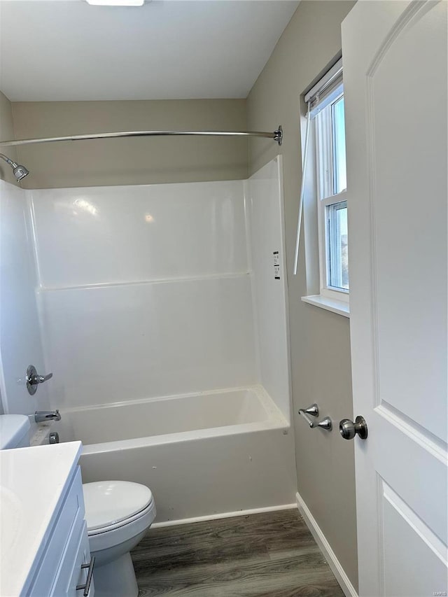 full bathroom featuring toilet, vanity, tub / shower combination, and hardwood / wood-style flooring