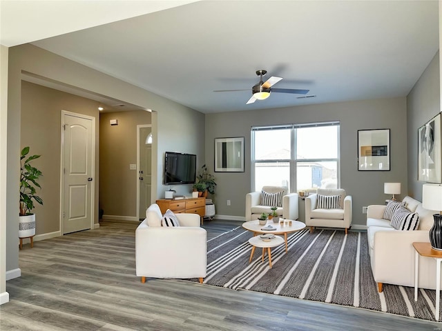 living room featuring ceiling fan and hardwood / wood-style flooring