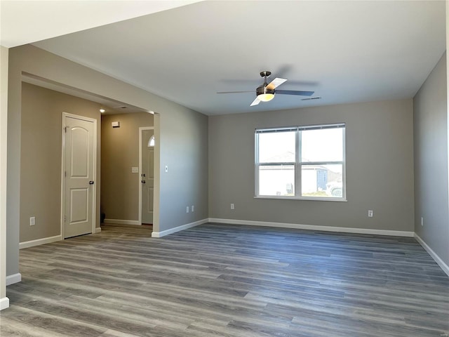 empty room featuring ceiling fan and hardwood / wood-style floors