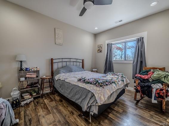 bedroom with ceiling fan and dark hardwood / wood-style floors