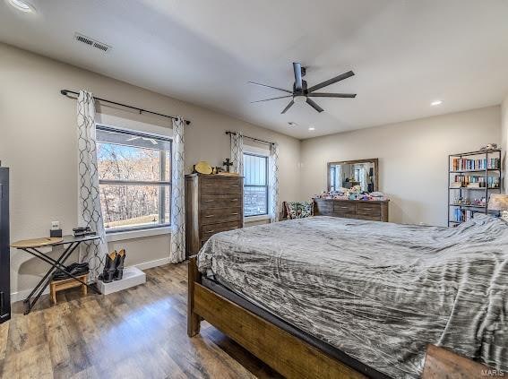 bedroom with wood-type flooring and ceiling fan