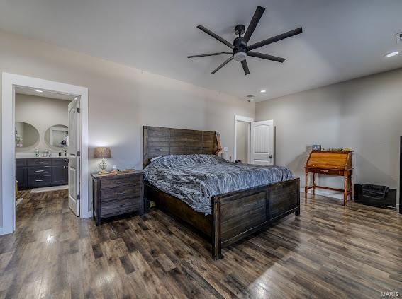 bedroom featuring ceiling fan, ensuite bath, and dark hardwood / wood-style flooring