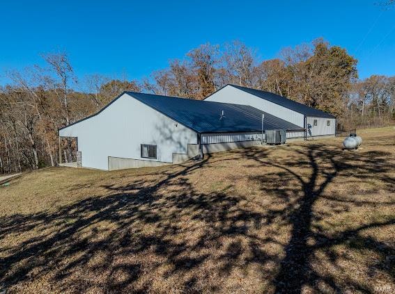 view of side of home with a yard