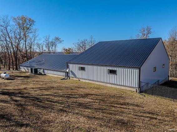 back of property featuring a lawn