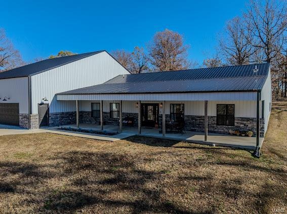 back of house featuring a patio and a lawn