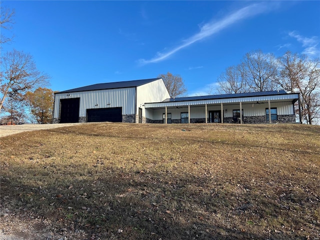 view of outbuilding featuring a garage and a lawn