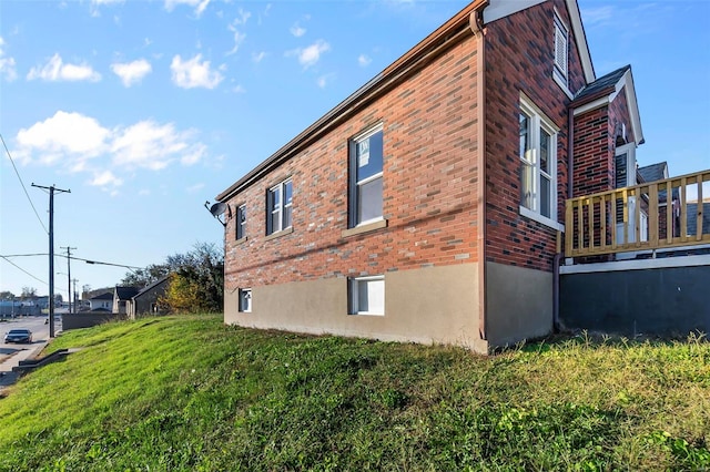 view of side of property with a lawn