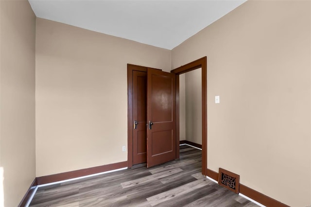 spare room with hardwood / wood-style floors