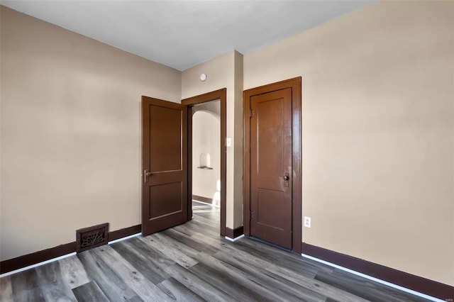 unfurnished room featuring dark hardwood / wood-style flooring