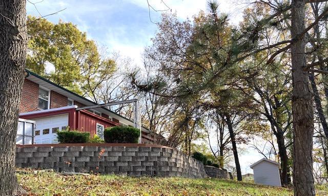 view of side of home with a garage and brick siding