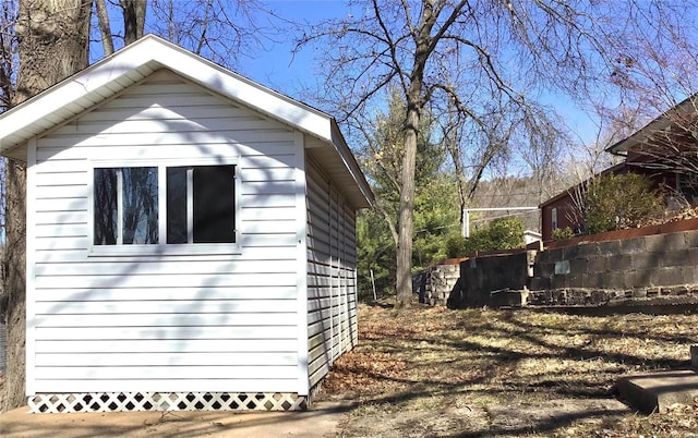 view of side of property featuring a storage shed and an outdoor structure