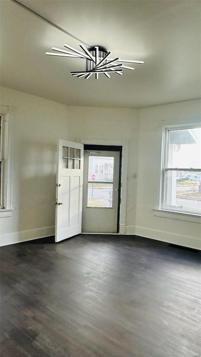 foyer entrance featuring a notable chandelier and dark hardwood / wood-style floors