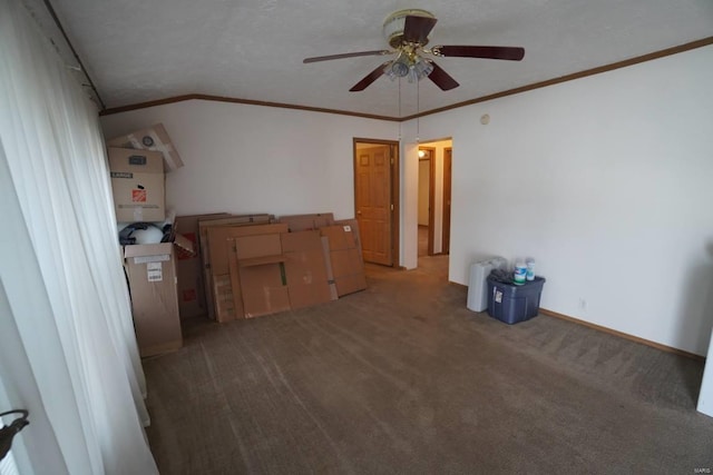 carpeted spare room with ornamental molding, vaulted ceiling, ceiling fan, and a textured ceiling