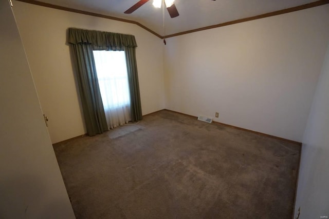 carpeted empty room featuring lofted ceiling, ceiling fan, and crown molding