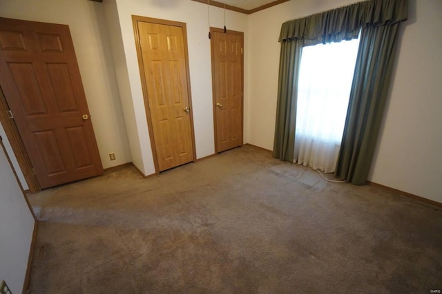 unfurnished bedroom with carpet flooring and ornamental molding