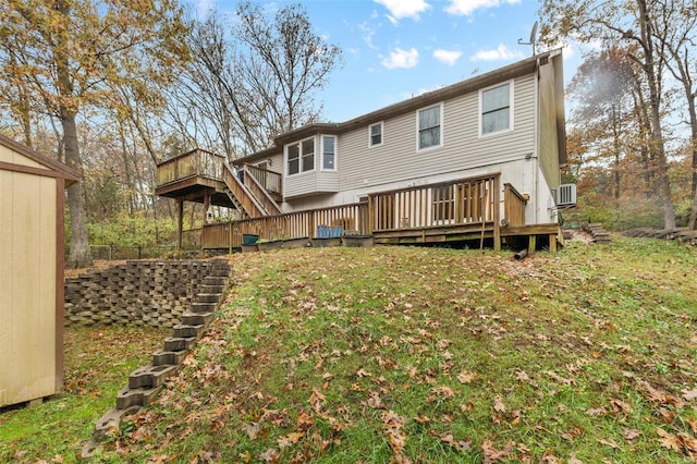 rear view of property with a lawn and a wooden deck