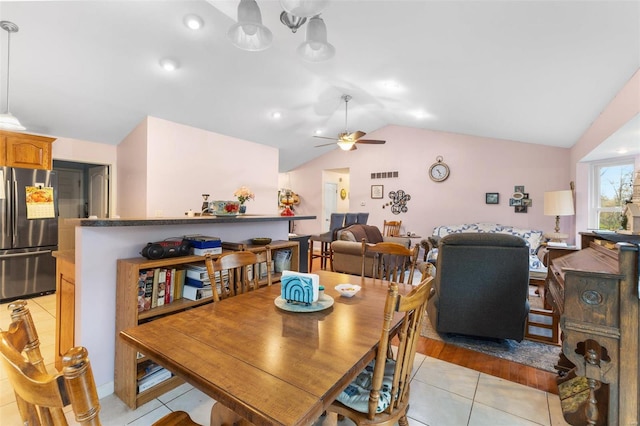 dining room featuring light hardwood / wood-style floors, ceiling fan, and lofted ceiling