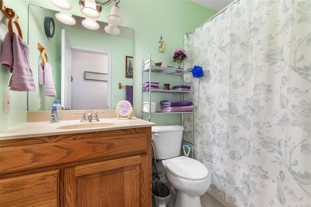 bathroom with curtained shower, vanity, and toilet