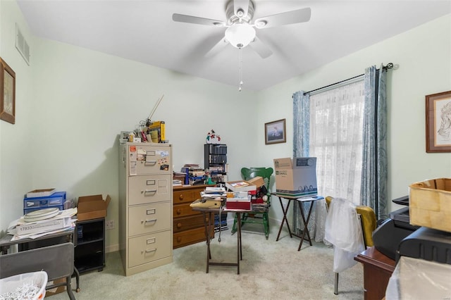 carpeted office space with ceiling fan