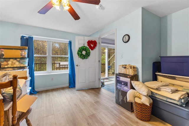 bedroom featuring light hardwood / wood-style floors, ceiling fan, and multiple windows