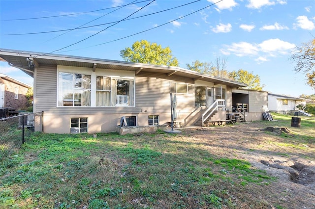 back of property featuring a lawn