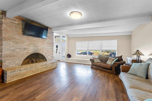 living room with dark wood-type flooring, a fireplace, and beam ceiling