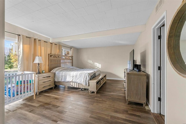 bedroom with dark hardwood / wood-style floors and lofted ceiling with beams