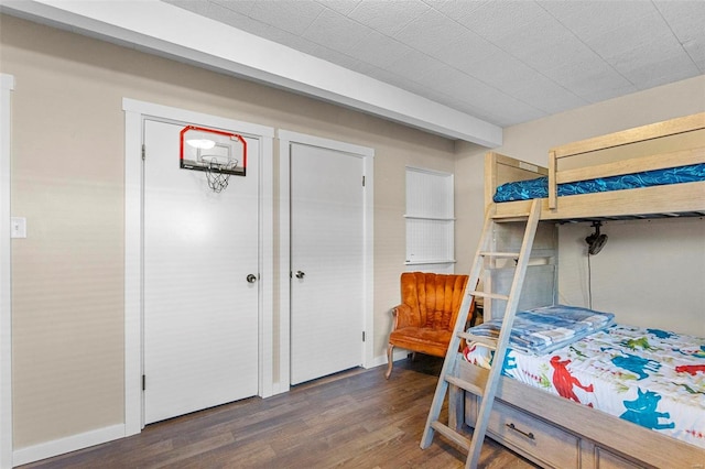 bedroom with dark hardwood / wood-style floors