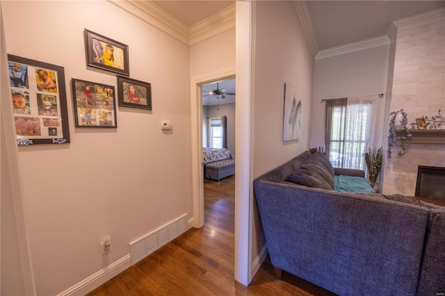 hall featuring ornamental molding, dark hardwood / wood-style floors, and plenty of natural light