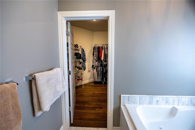 bathroom featuring hardwood / wood-style flooring and a tub