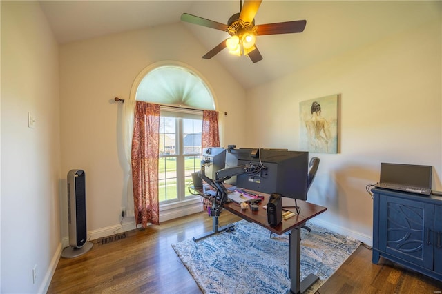 home office with dark hardwood / wood-style flooring, ceiling fan, and vaulted ceiling