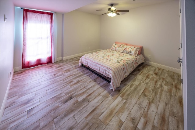 bedroom with ceiling fan and light hardwood / wood-style flooring